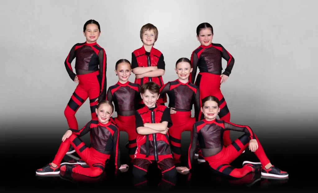 Hip hop classes represented by group of girls and boys in black and red costumes