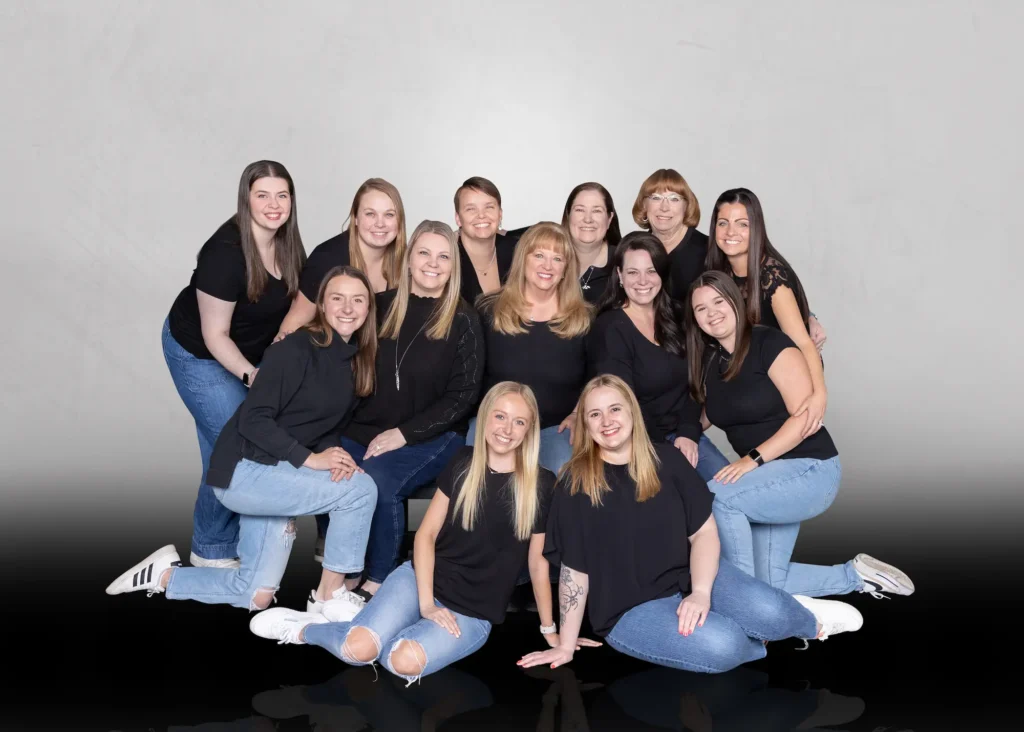 Group of Arabesque School of Dance instructors and staff wearing black shirts and jeans.