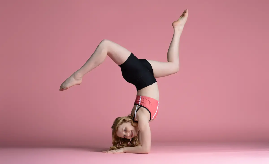 Middle school-aged dance doing a handstand pose to represent acro classes at Arabesque School of Dance in Blaine, MN